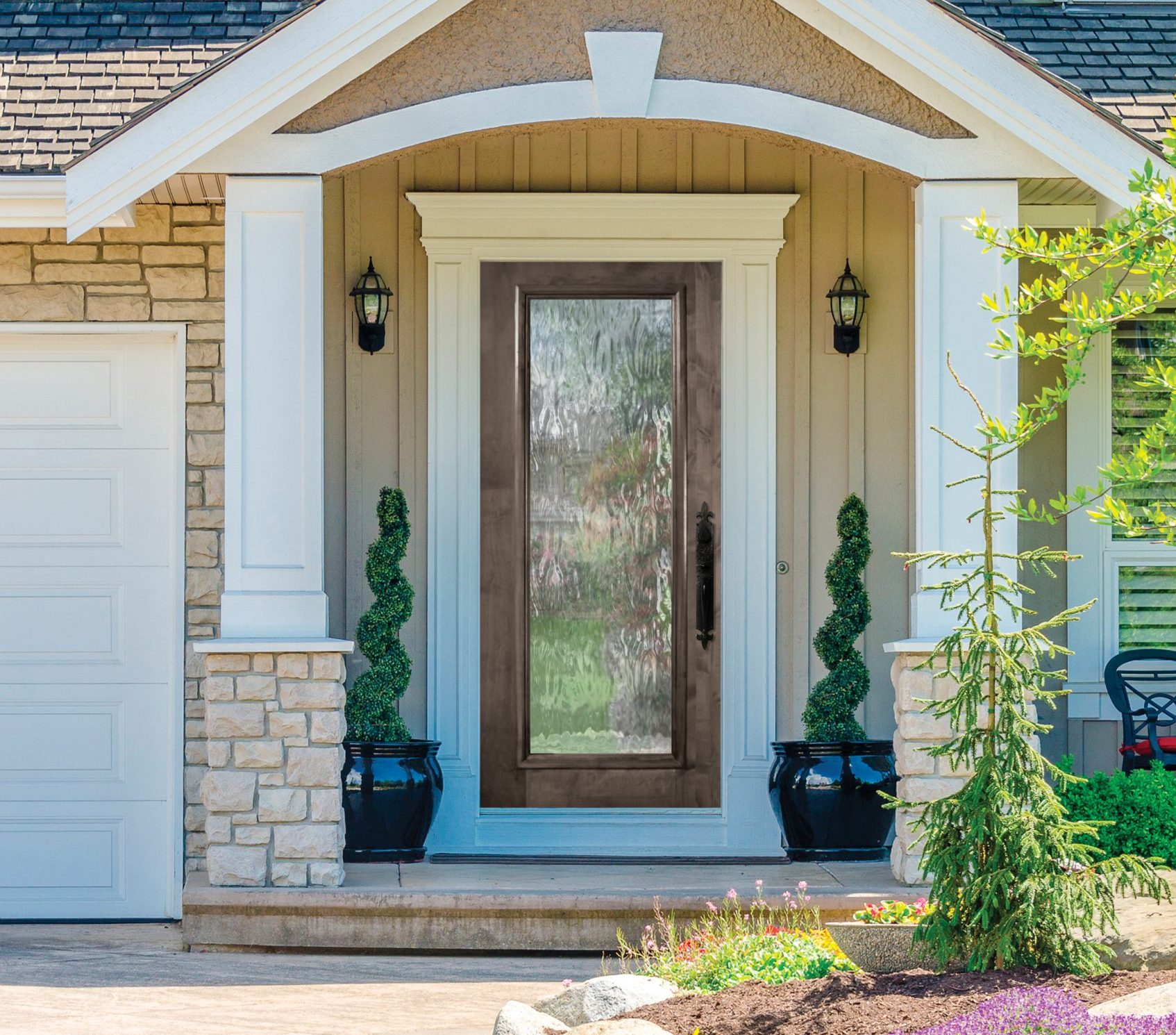 A nice entrance of a luxury house with a wood door by glasscraft